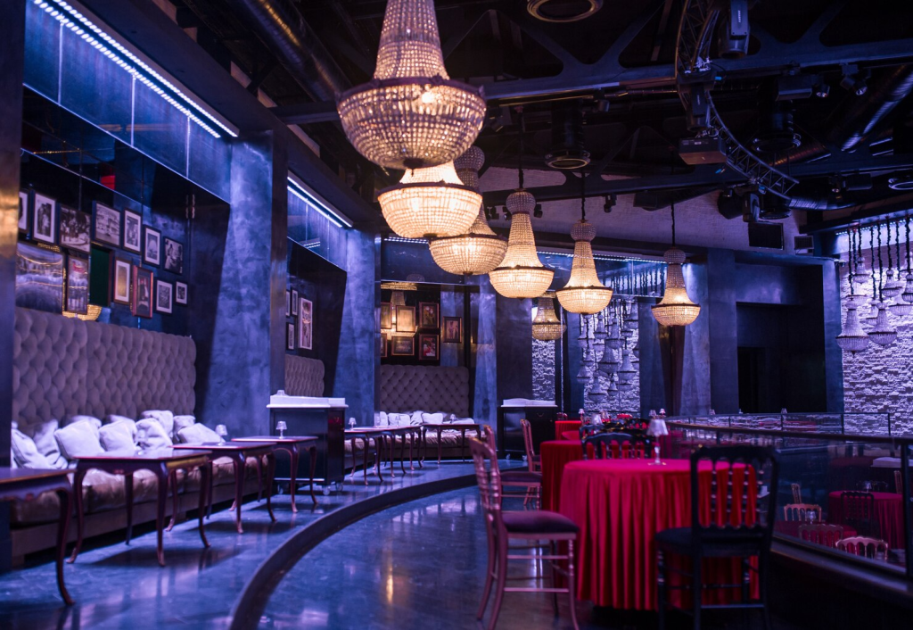 Crystal chandeliers layered through a hotel restaurant interior