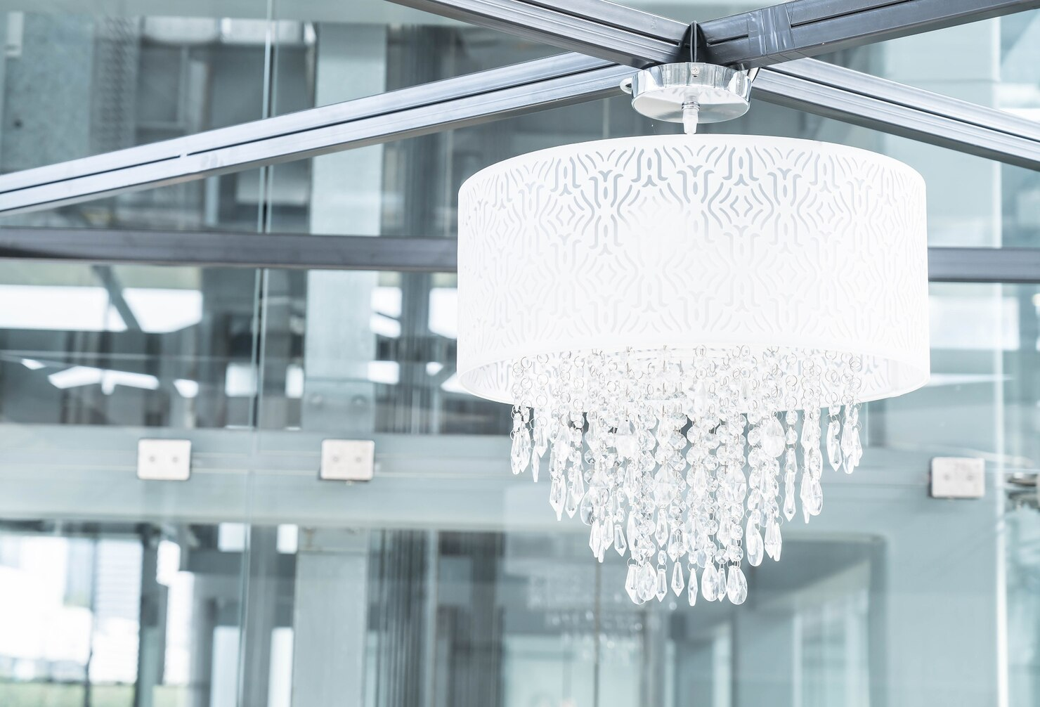 Contemporary crystal chandelier installed in a modern commercial interior