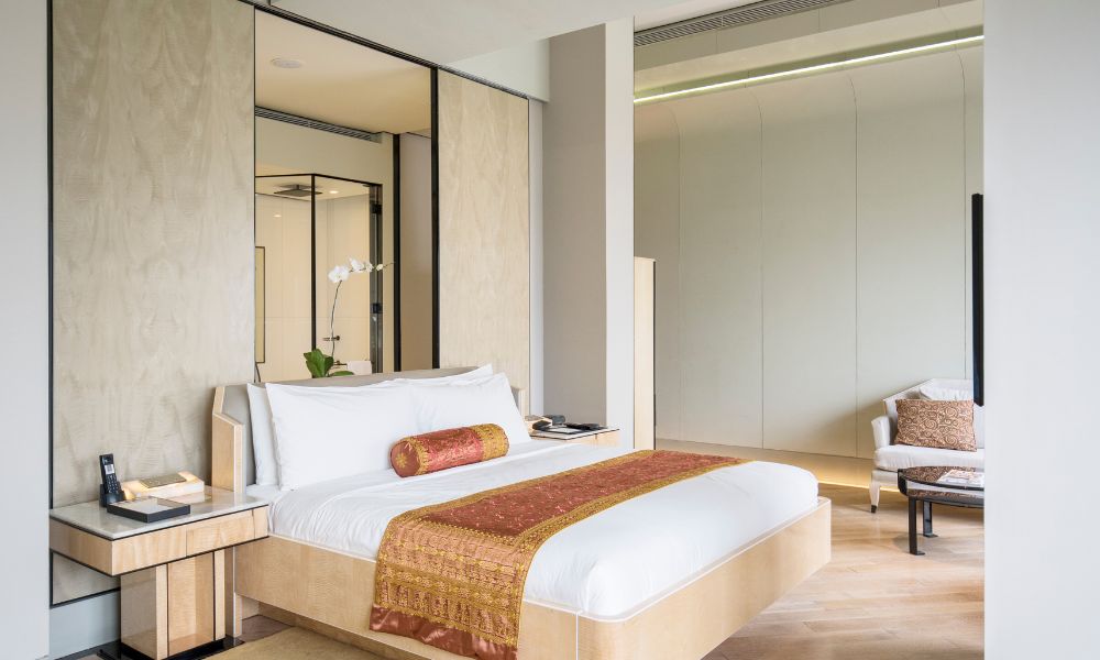 Hotel guest room with coordinated casegoods lighting finishes and soft furnishings