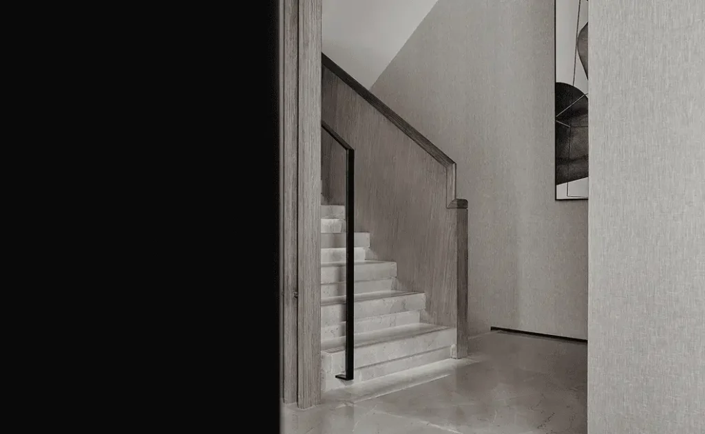 Modern stone staircase showing tread edges, guard and handrail design