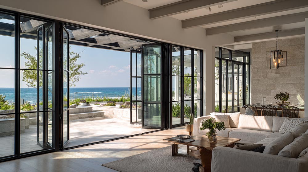 Custom aluminum impact windows on a modern coastal home