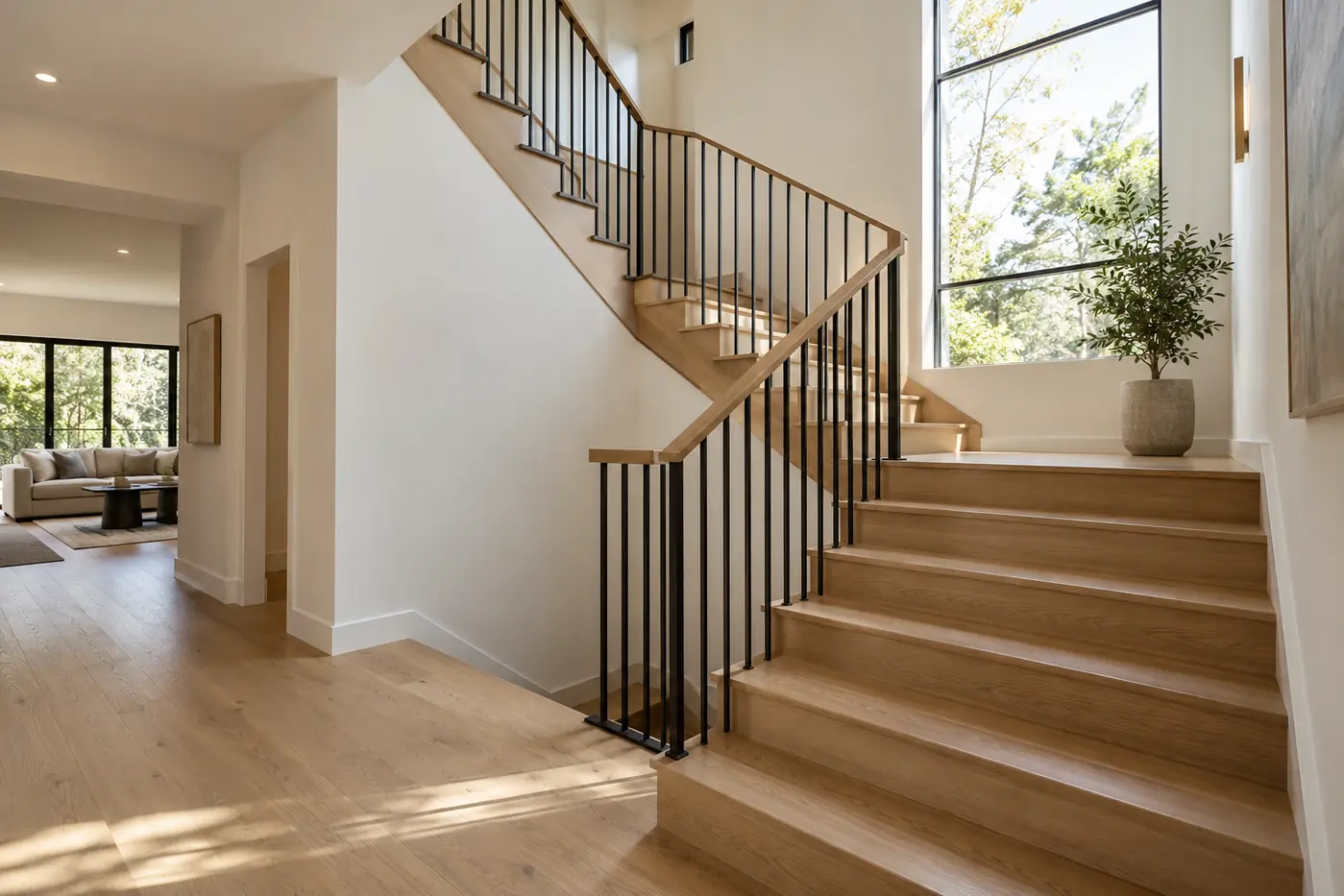 Oak turning staircase with an intermediate landing and black metal railing